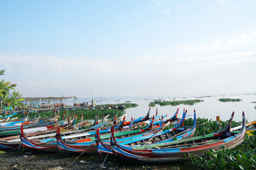 Landscape - nature scene of traditional boat on the lake at u bein bridge is famous landmark in Mandalay, Burma (Myanmar)