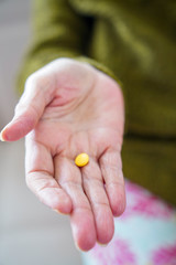 pills in a Senior's hands. Painful old age. Caring for the health of the elderly