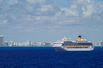 Huge modern Costa Cruises cruiseship or cruise ship liner Costa Magica at sea with skyline of Miami...