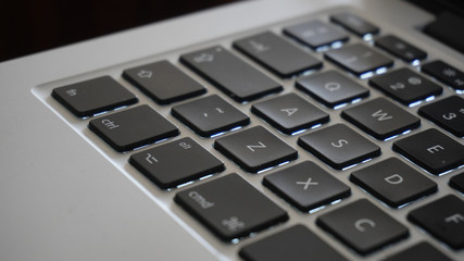 Photography close up shot of laptop or computer corner with keyboard keys