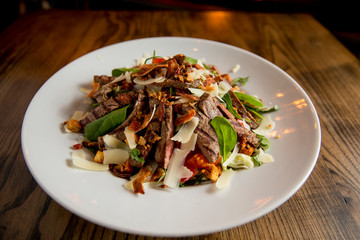 Beefsteak salad with lettuce, rocket,  and spinach with parmesan and .homemade spicy croutons