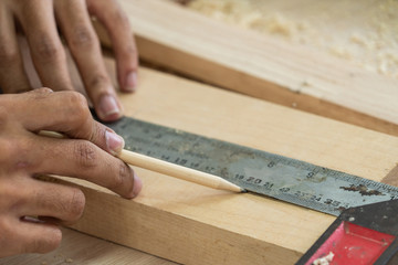 Carpenter working on wood craft at workshop to produce construction material or wooden furniture....