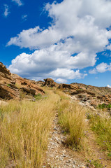 Path by the rocky coast on Paros island near Monastiri bay. Cyclades, Greece