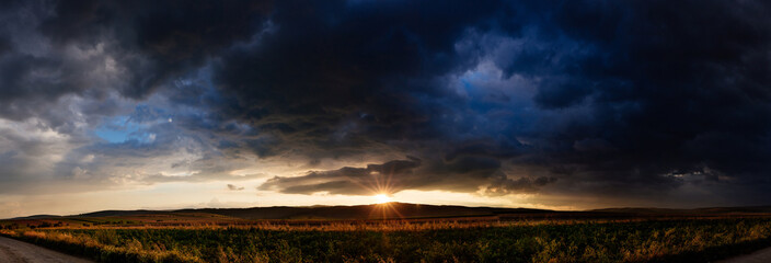 Beautifull golden sunset with dramatic rain clouds