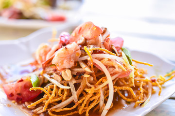 A twist on traditional salads, Fried Papaya Salad..Deep fried papaya with shrimp serve with Thai style sauce.Thai food - green papaya salad with mixed dried shrimp or dried salted prawn (som tum thai)