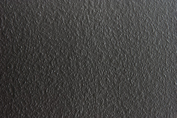 Uniform grey roughly textured wall 