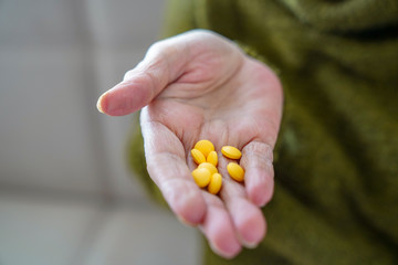 pills in a Senior's hands. Painful old age. Caring for the health of the elderly