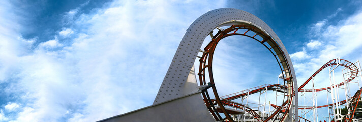 roller coaster track, children carousel on a background of blue sky, panoramic mock-up - obrazy, fototapety, plakaty