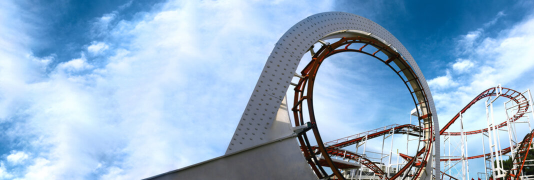 roller coaster track, children carousel on a background of blue sky, panoramic mock-up
