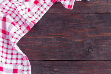 A red checked towel on an old wooden table.