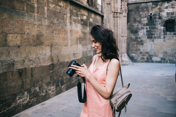 Traveler looking through photos in ancient city