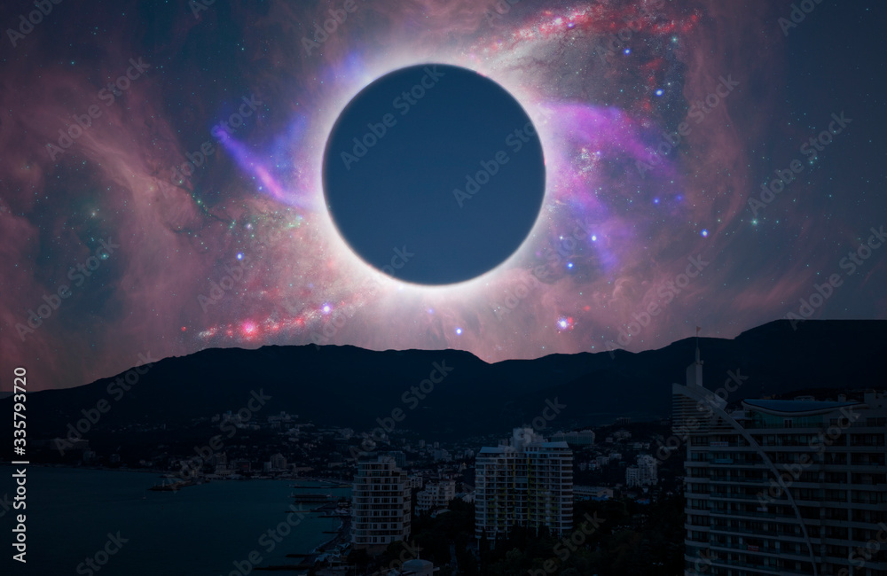 Wall mural the solar eclipse in the sky over the city, elements of this image is furnished by nasa