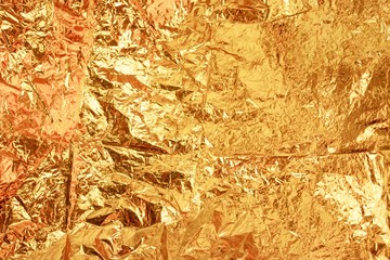 Closeup shot of a crumpled golden candy wrapper