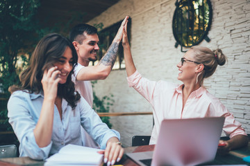Excited coworkers working and celebrating success