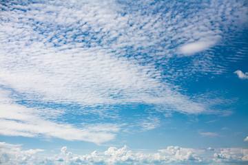 Beautiful blue sky with porous white clouds.