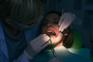 Closeup dental examination on a female patient in the dentist's office