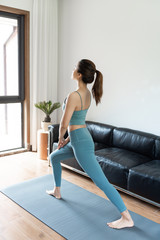 Fototapeta na wymiar A young Asian woman doing yoga at home
