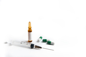 Coronavirus 2019-nCoV outbreak. Pills and syringe on a white isolated background.