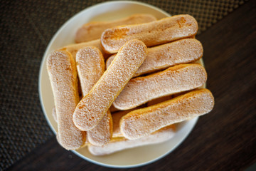 Savoiardi biscuits on the plate with copy space
