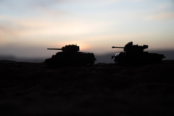 Fototapeta na wymiar War Concept. Military silhouettes fighting scene on war fog sky background, World War Soldiers Silhouette Below Cloudy Skyline At sunset.