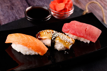 sushi with chopsticks on a black plate