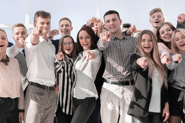 group of diverse young people pointing at the camera