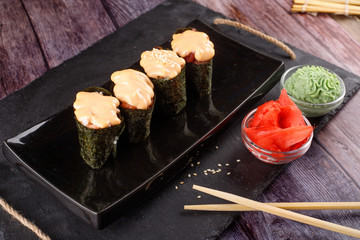Baked sushi, rolls sprinkled with sesame seeds,