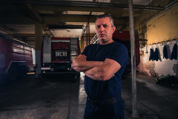 Portrait of fireman standing inside the fire department