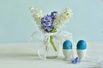Easter decorations with painted eggs with Hyacinth on pastel color background, Spring greeting card. copy space.
