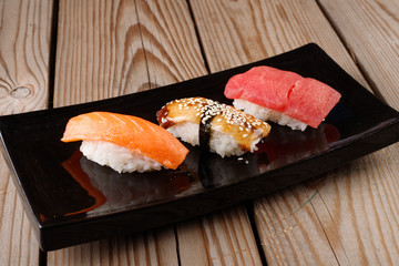 sushi with chopsticks on a black plate