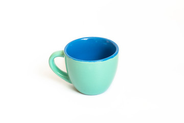 Little empty ceramic turquoise and blue coffee mug , coffee cup isolated on white background