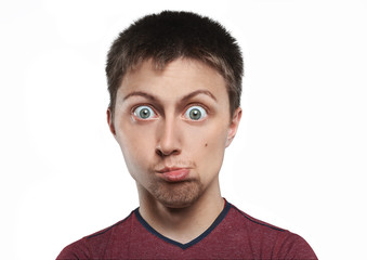 Fototapeta premium A guy with a cartoon big head on a white background with funny facial expressions