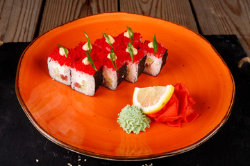 Rolls, wasabi, soy sauce, ginger on the table, avocado.