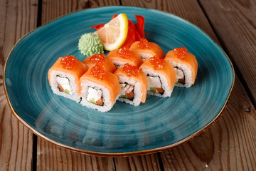Rolls, wasabi, soy sauce, ginger on the table, avocado.