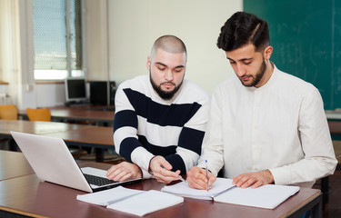 Students working with laptop at desk