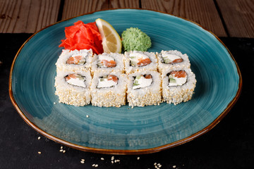 Rolls, wasabi, soy sauce, ginger on the table, avocado.