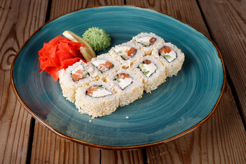 Rolls, wasabi, soy sauce, ginger on the table, avocado.