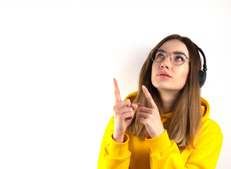 Student, a young woman in glasses and headphones shows
