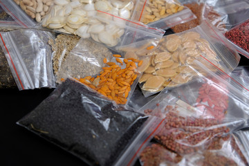 packaged in a variety of organic non-GMO seeds on a black background,