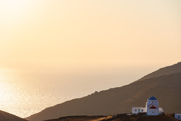 Fototapeta na wymiar An old traditional isolated church in the countryside of Serifos island in Cyclades Aegean Greece during sunset