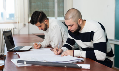 Students working with laptop at desk