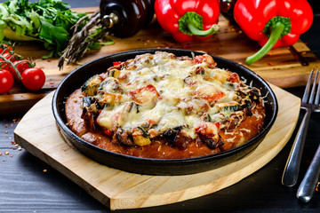 homemade pizza in a pan from the oven with vegetables