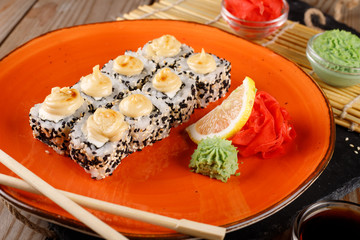 Baked sushi, rolls sprinkled with sesame seeds