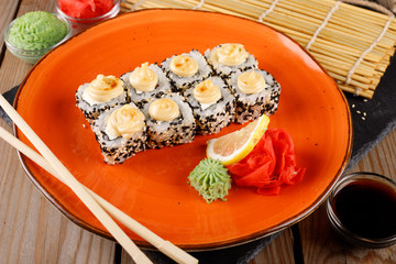Baked sushi, rolls sprinkled with sesame seeds