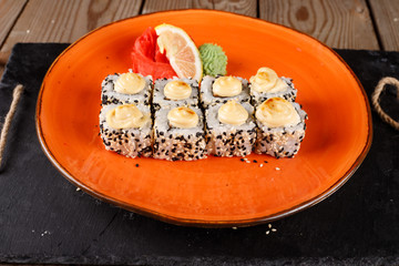 Baked sushi, rolls sprinkled with sesame seeds