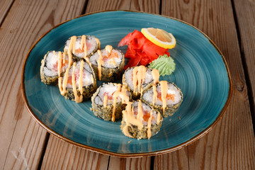 Baked sushi, rolls sprinkled with sesame seeds,