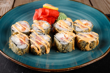 Baked sushi, rolls sprinkled with sesame seeds,