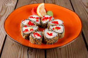 Baked sushi, rolls sprinkled with sesame seeds