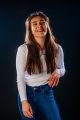 Portrait of an attractive girl holing her hair, while looking handsome and satisfied.