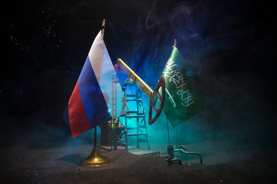 Business dialogue, oil agreement concept: National flags with Oil pump and oil refining factory at night with fog and backlight. Energy industrial concept.